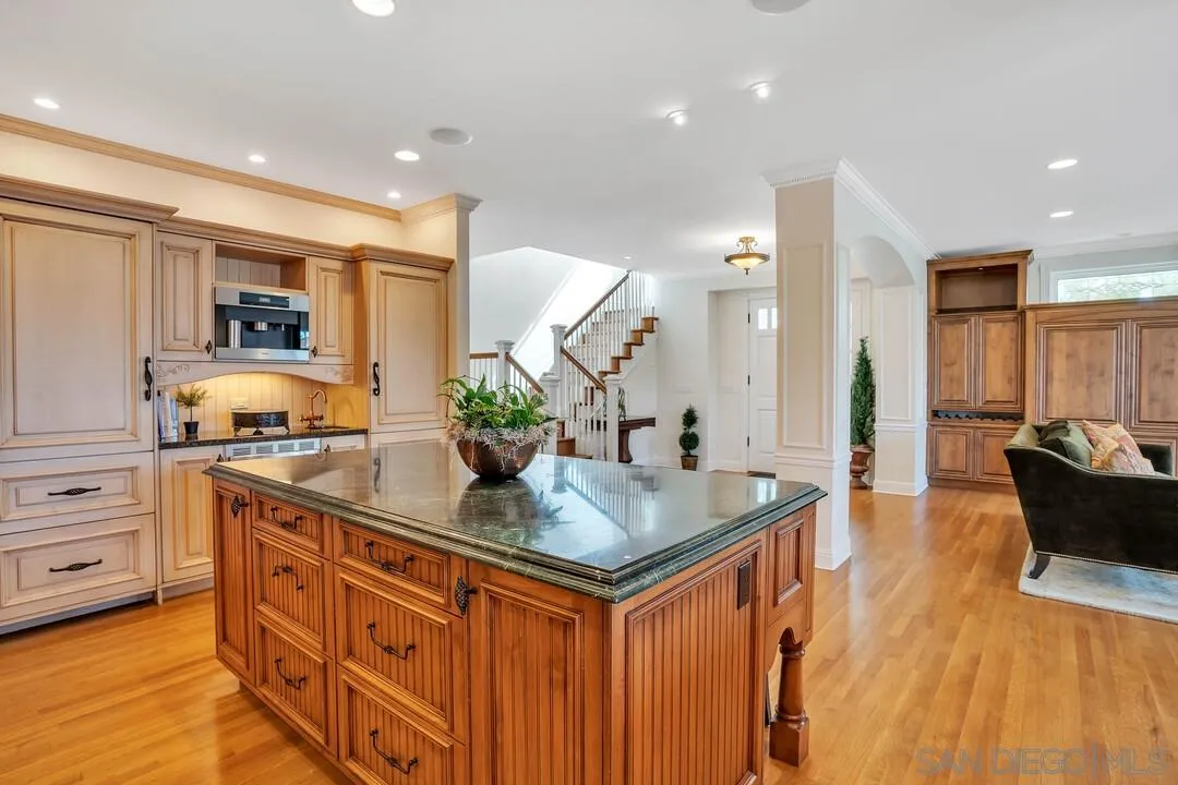5735 Dolphin Place La Jolla, CA 92037 - Photo 6 of 75 a kitchen with stainless steel appliances granite countertop a sink a stove and a wooden floors