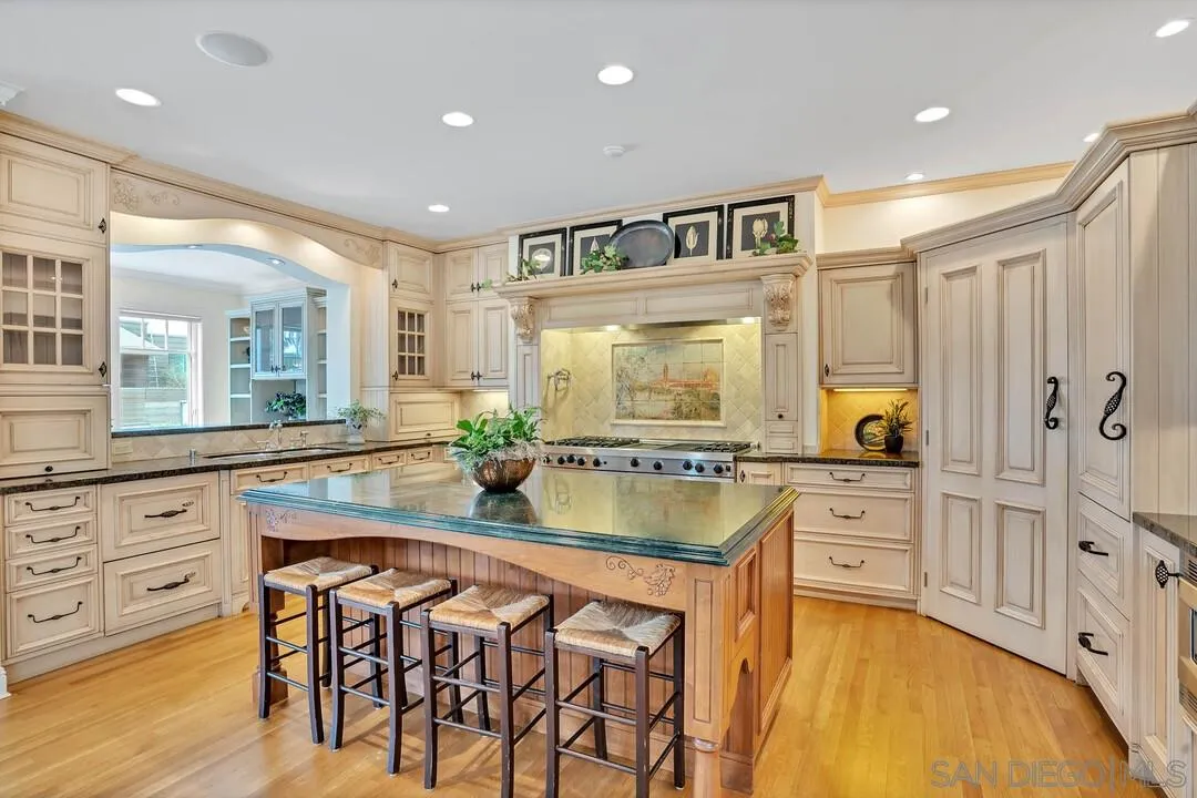 5735 Dolphin Place La Jolla, CA 92037 - Photo 10 of 75 a kitchen with stainless steel appliances granite countertop a stove a sink and a refrigerator