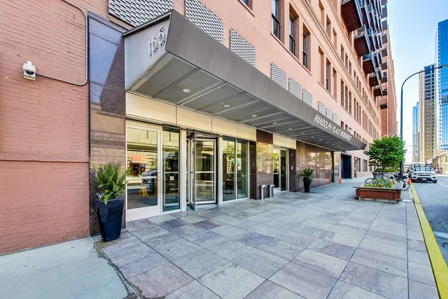 a spacious bedroom with a balcony a bed and a large window