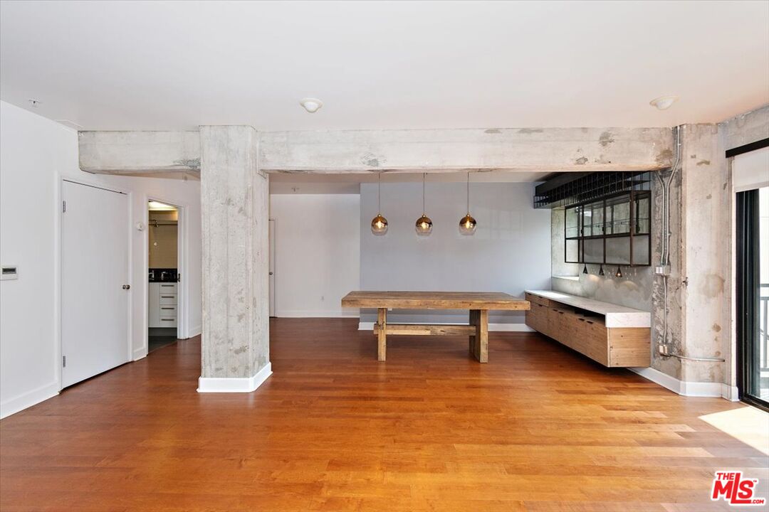 416 South Spring Street, Unit 609 Los Angeles, CA 90013 - Photo 11 of 24 a living room with furniture and a wooden floor