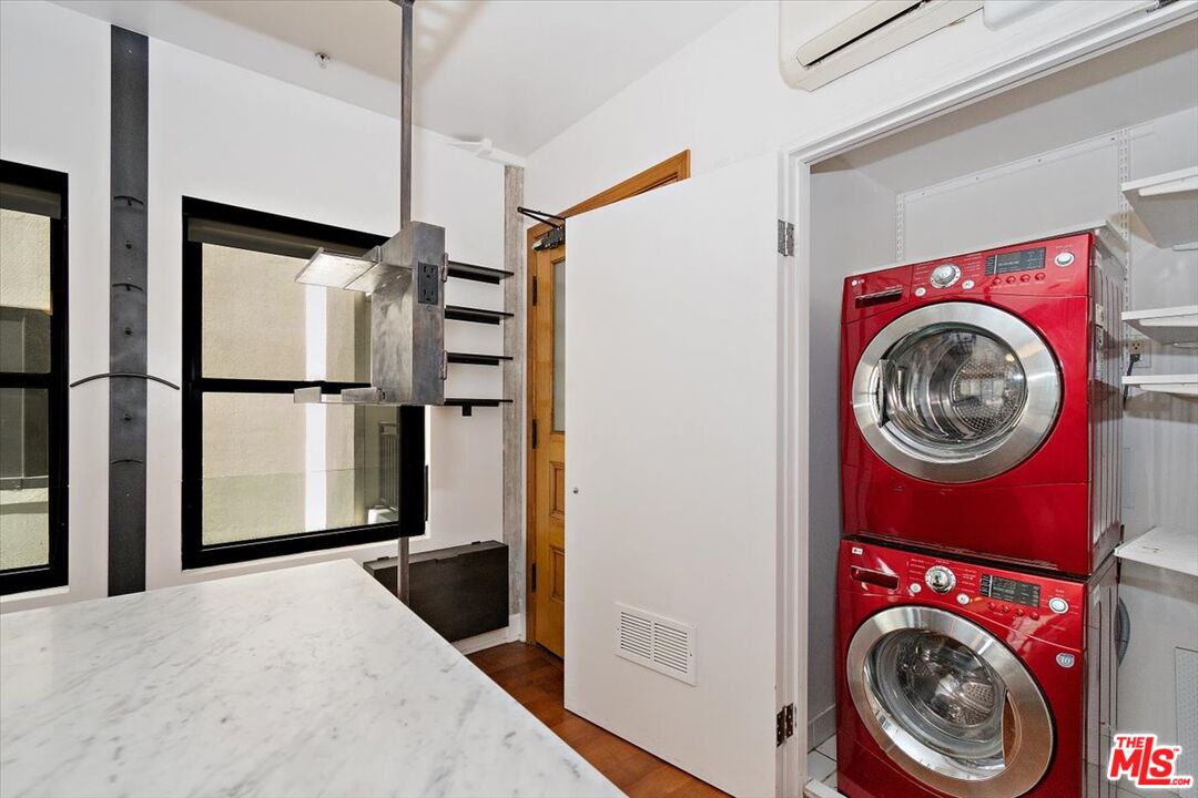 416 South Spring Street, Unit 609 Los Angeles, CA 90013 - Photo 13 of 24 a view of a bedroom with washer and dryer