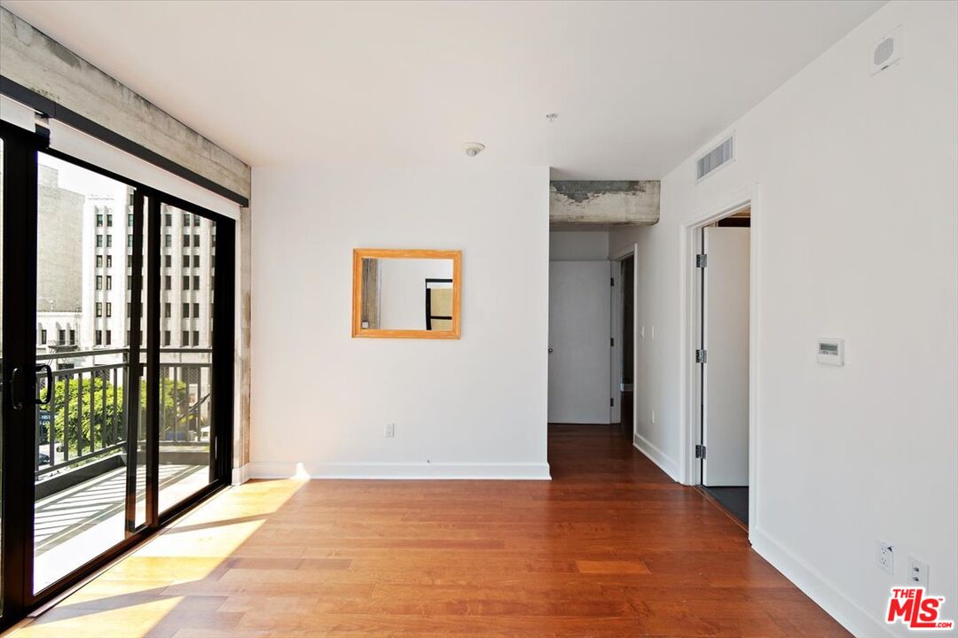 416 South Spring Street, Unit 609 Los Angeles, CA 90013 - Photo 19 of 24 a view of an empty room with glass door
