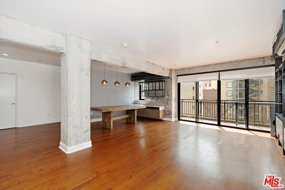 416 South Spring Street, Unit 609 Los Angeles, CA 90013 - Photo 6 of 24 a view of empty room with wooden floor and floor to ceiling window