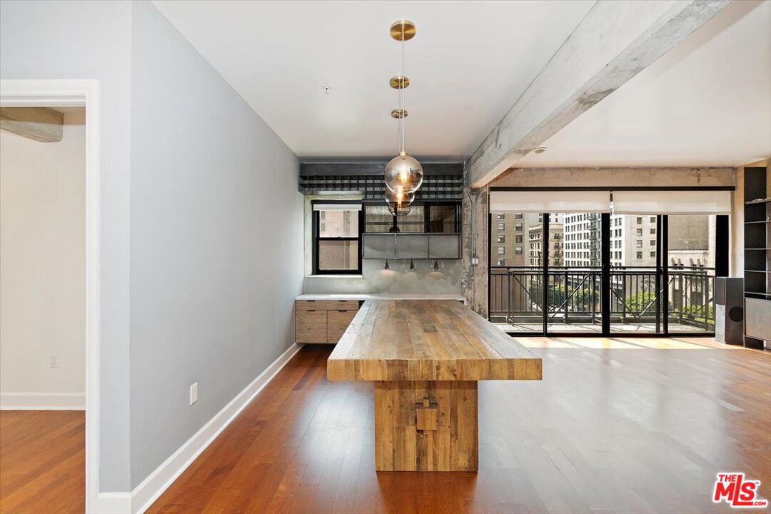416 South Spring Street, Unit 609 Los Angeles, CA 90013 - Photo 9 of 24 a room with lots of table and a large window