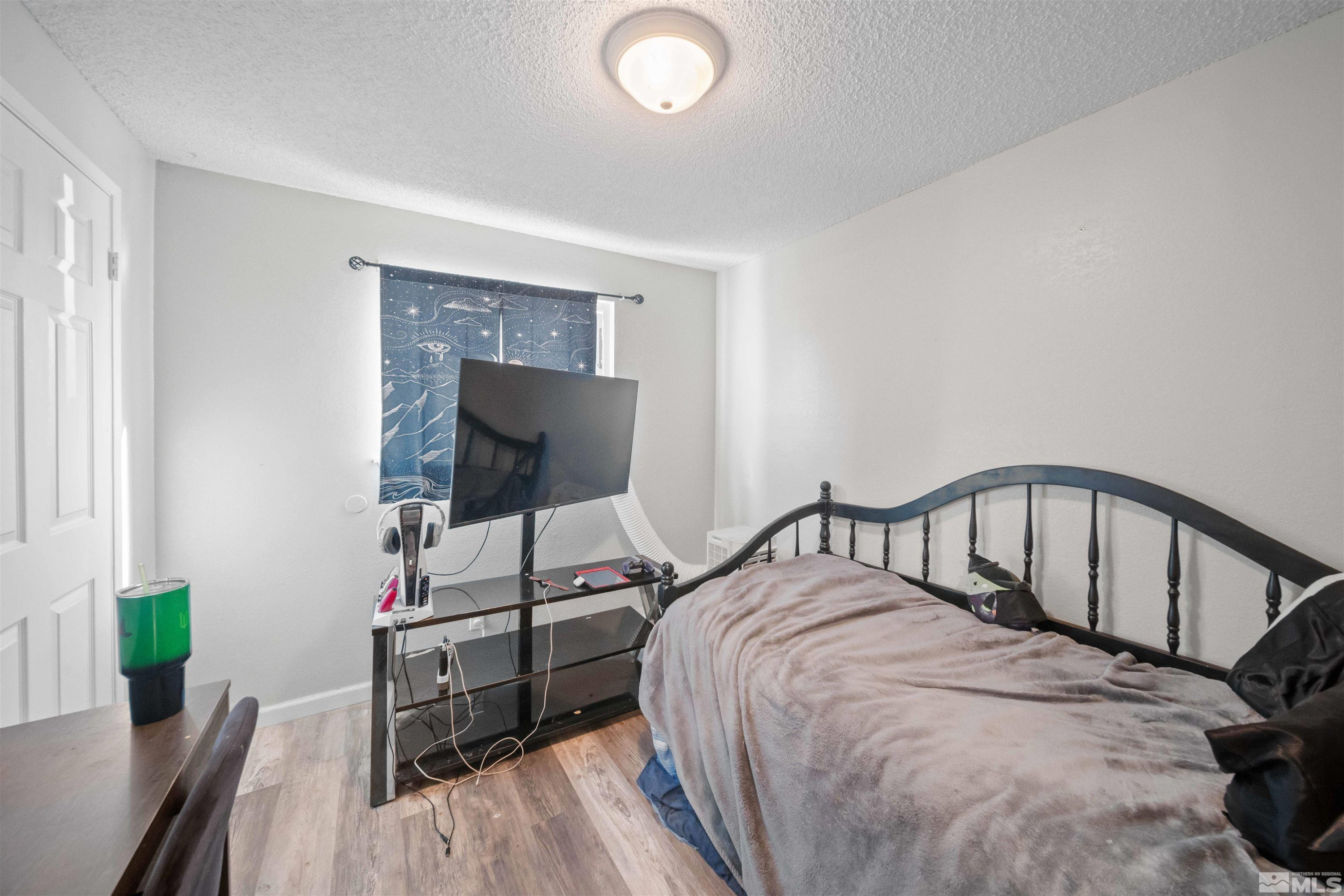 565 Spruce Drive Fernley, NV 89408 - Photo 13 of 19 a bedroom with a bed and a desk in it