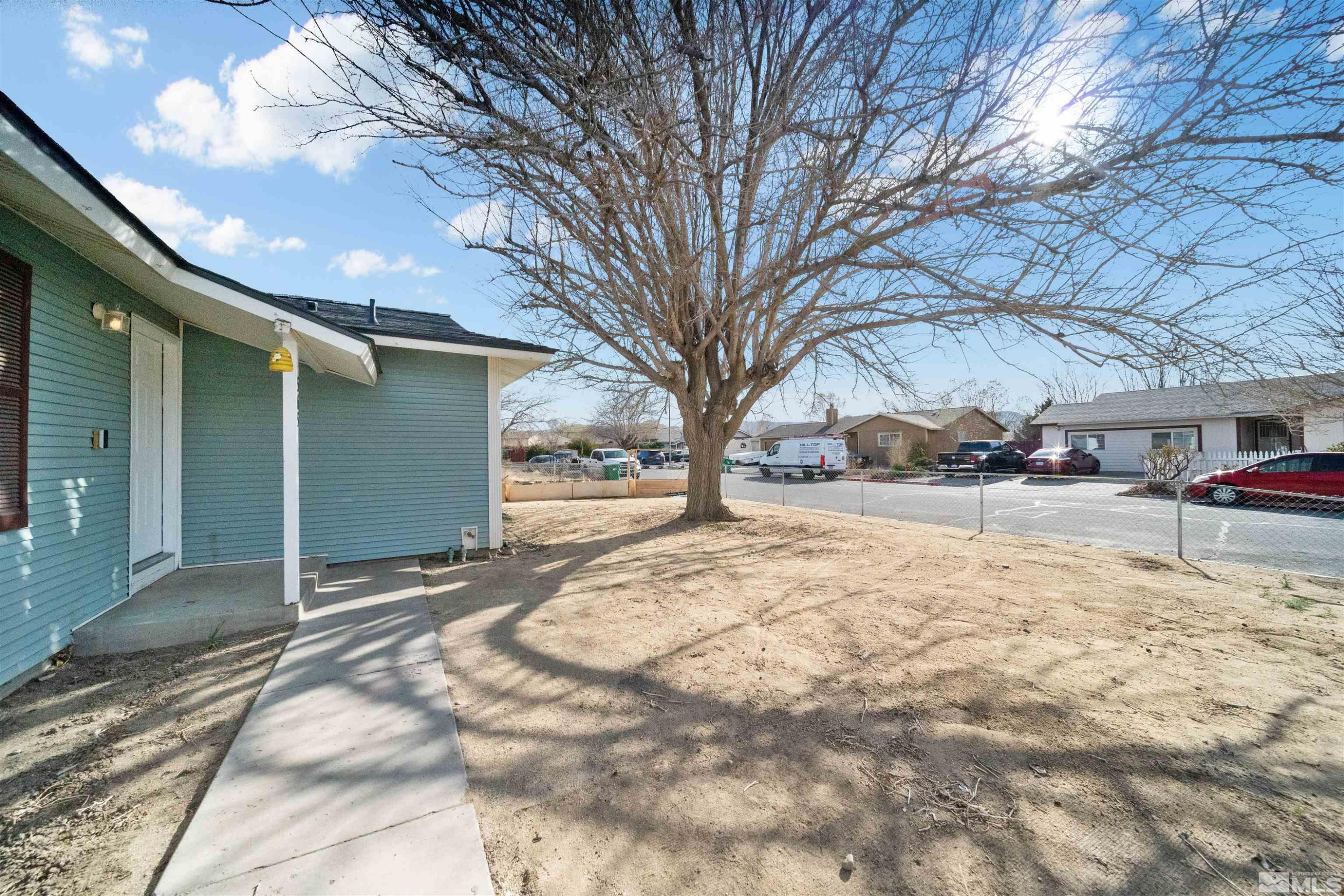 565 Spruce Drive Fernley, NV 89408 - Photo 3 of 19 a view of yard with tree in beside