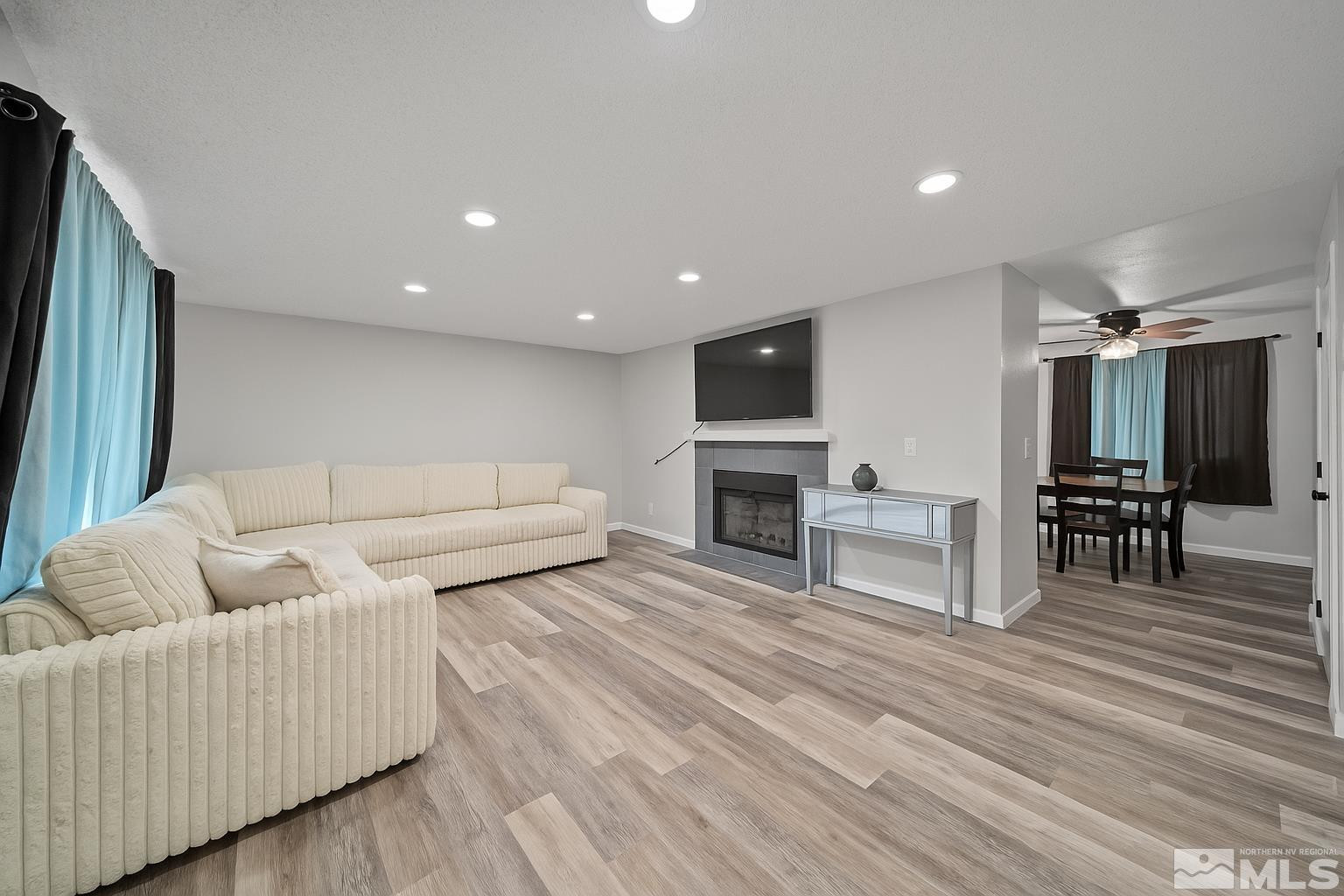 565 Spruce Drive Fernley, NV 89408 - Photo 5 of 19 a living room with furniture and a flat screen tv