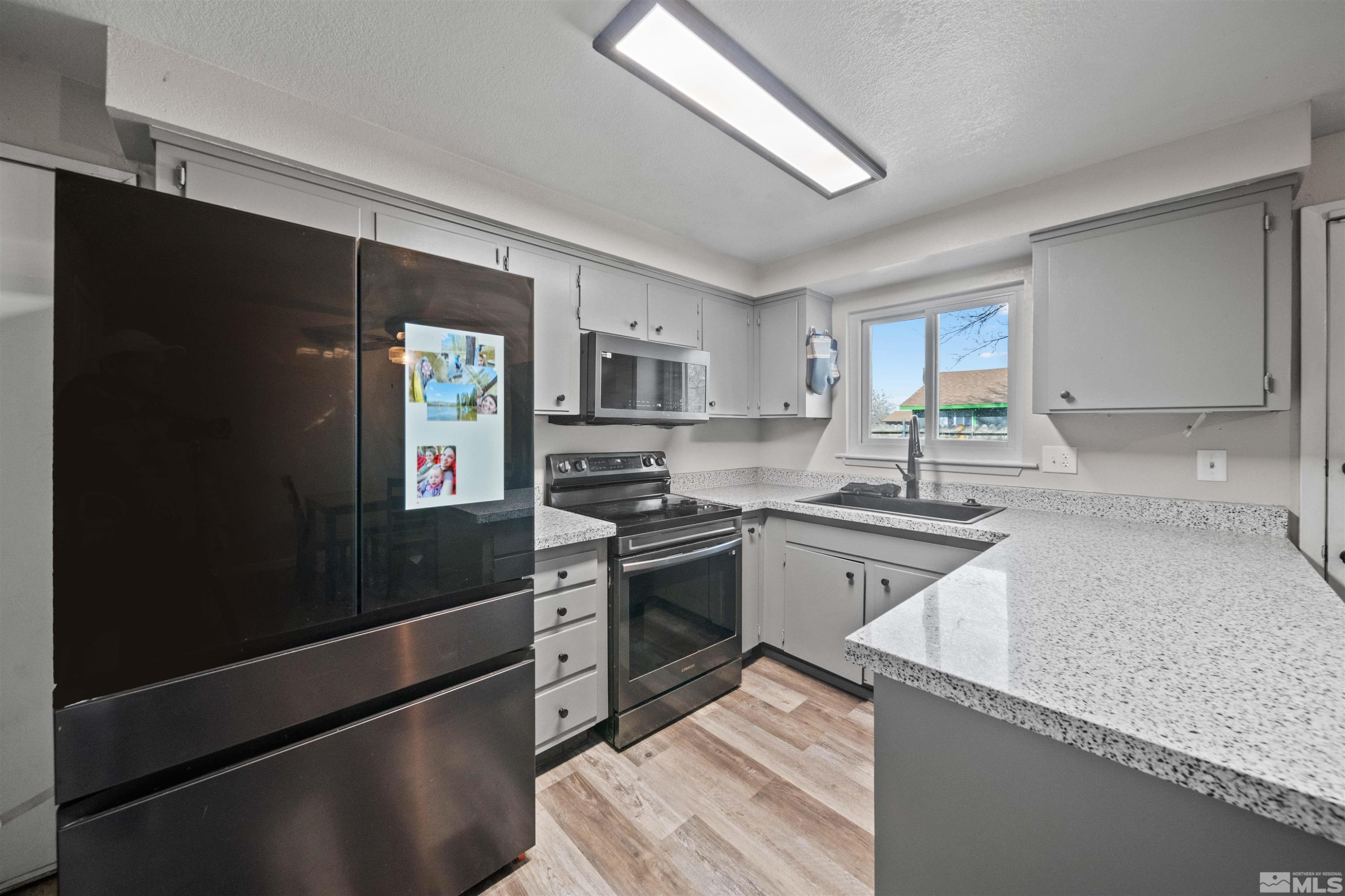 565 Spruce Drive Fernley, NV 89408 - Photo 7 of 19 a kitchen with granite countertop stainless steel appliances and sink