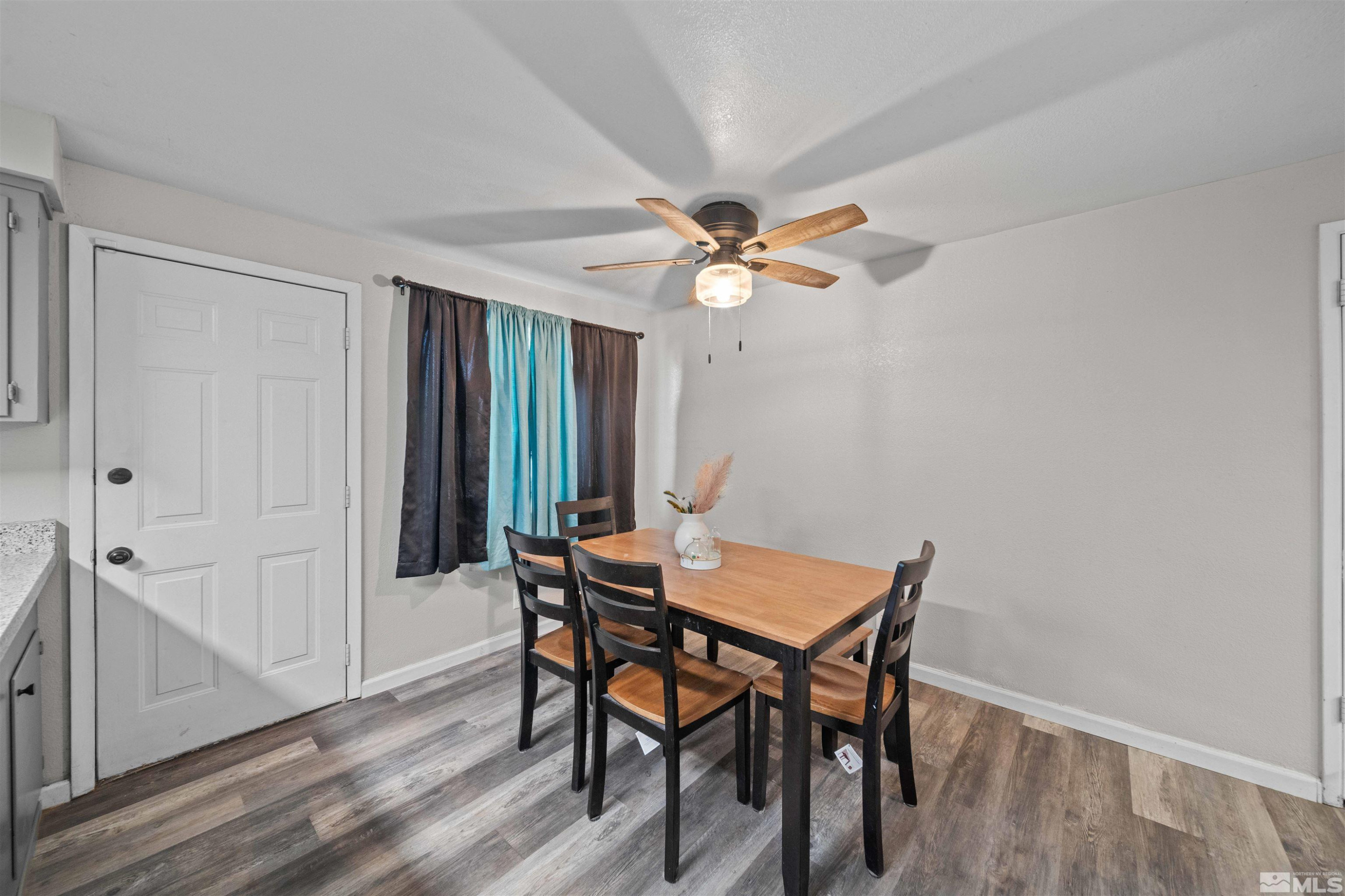 565 Spruce Drive Fernley, NV 89408 - Photo 8 of 19 a view of a dining room with furniture and a window