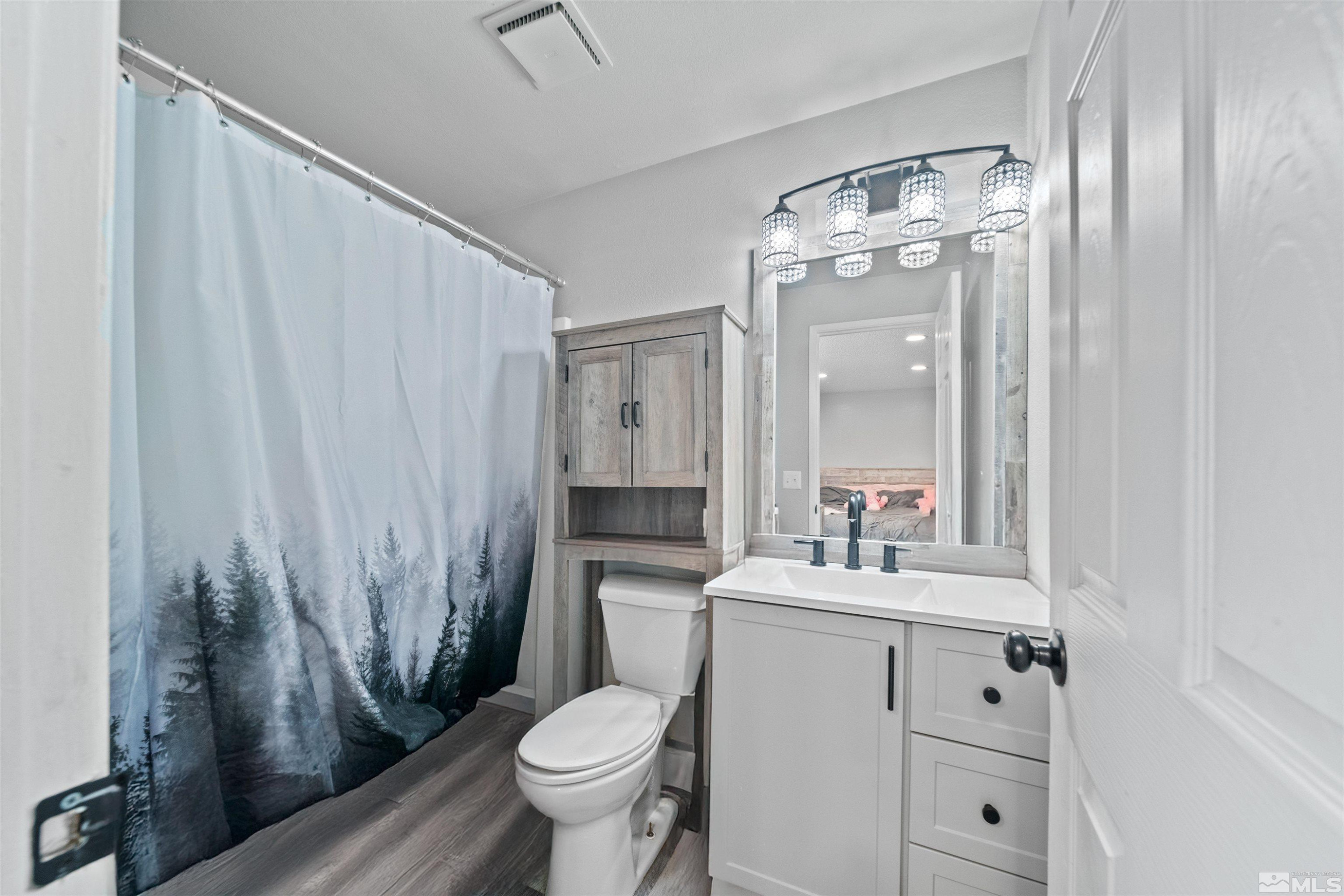 565 Spruce Drive Fernley, NV 89408 - Photo 10 of 19 a bathroom with a sink toilet and shower