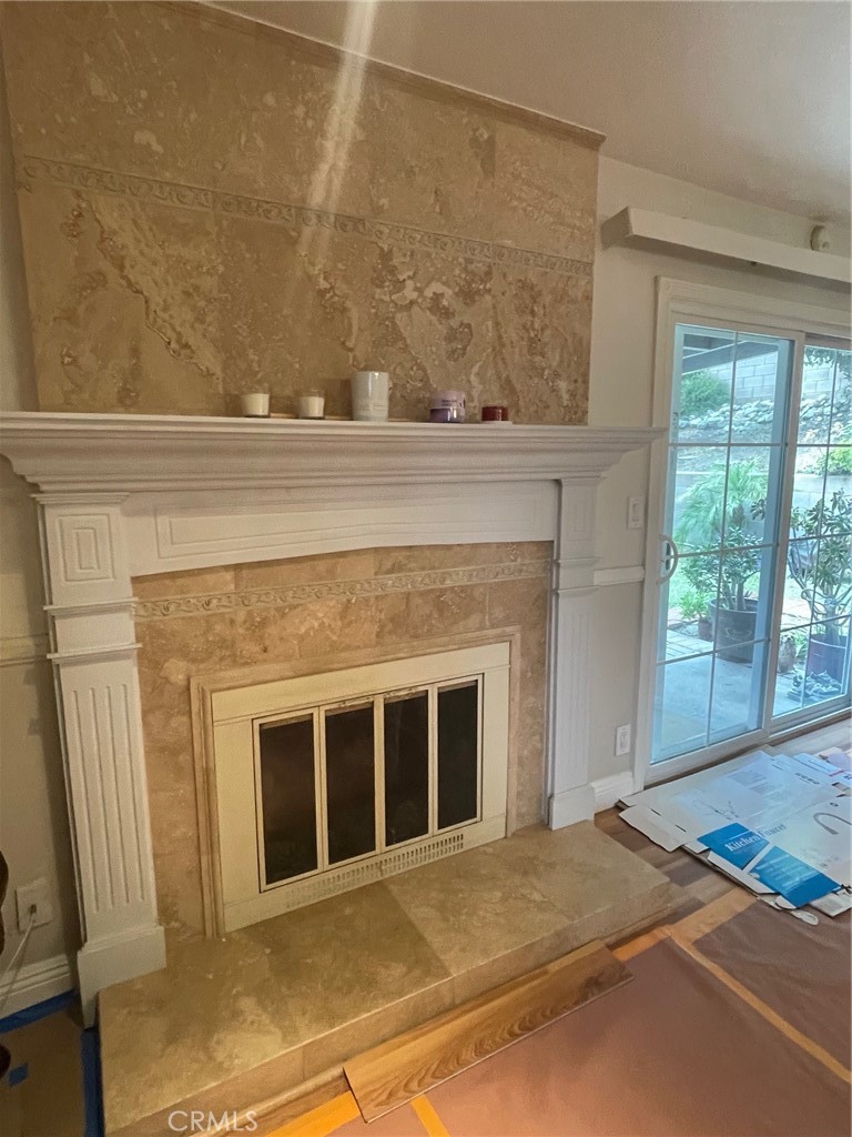6250 Filkins Avenue Rancho Cucamonga, CA 91737 - Photo 13 of 48 a living room with a fireplace and a floor to ceiling window