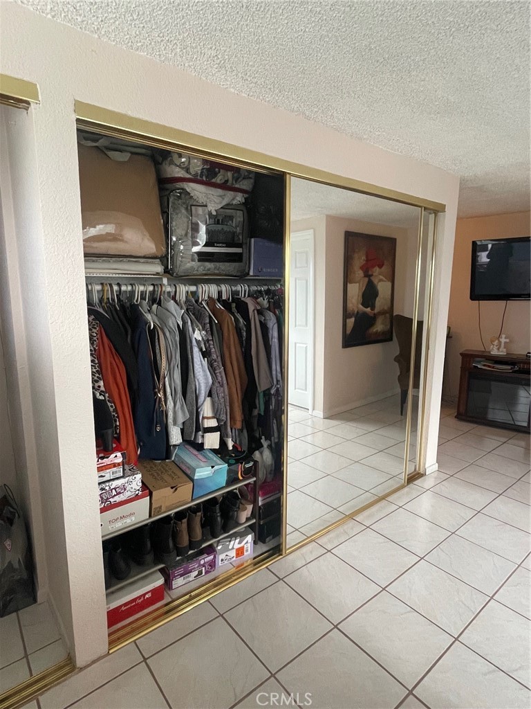 6250 Filkins Avenue Rancho Cucamonga, CA 91737 - Photo 25 of 48 a view of walk in closet with clothes and shoes