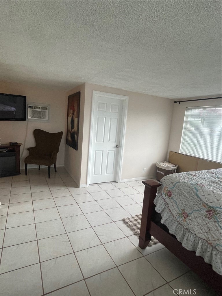 6250 Filkins Avenue Rancho Cucamonga, CA 91737 - Photo 27 of 48 a bedroom with a bed and a table in it