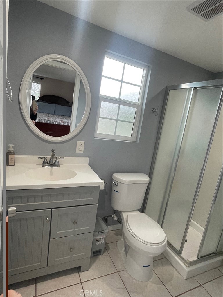 6250 Filkins Avenue Rancho Cucamonga, CA 91737 - Photo 29 of 48 a bathroom with a sink a toilet and a mirror