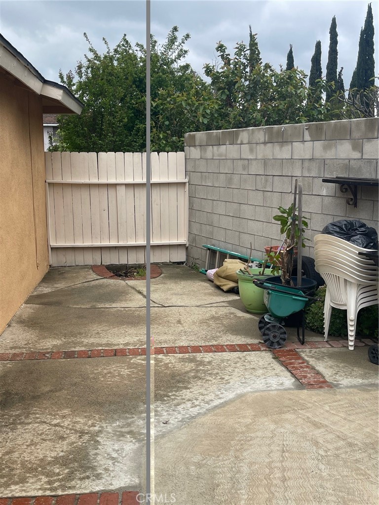 6250 Filkins Avenue Rancho Cucamonga, CA 91737 - Photo 43 of 48 a view of a backyard with chairs potted plants and a fountain