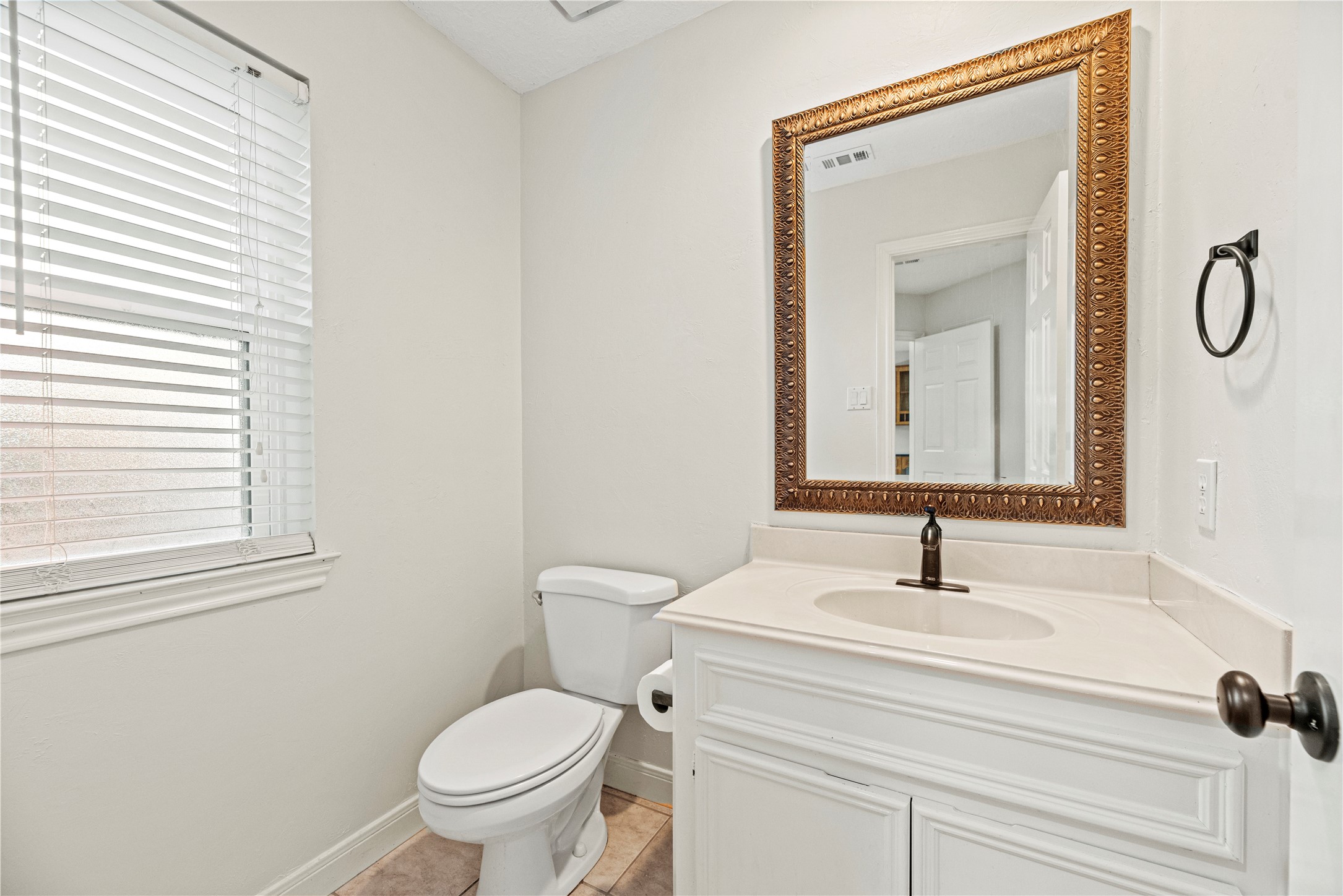 12502 Pavilion Court Tomball, TX 77377 - Photo 19 of 37 a bathroom with a toilet sink and mirror