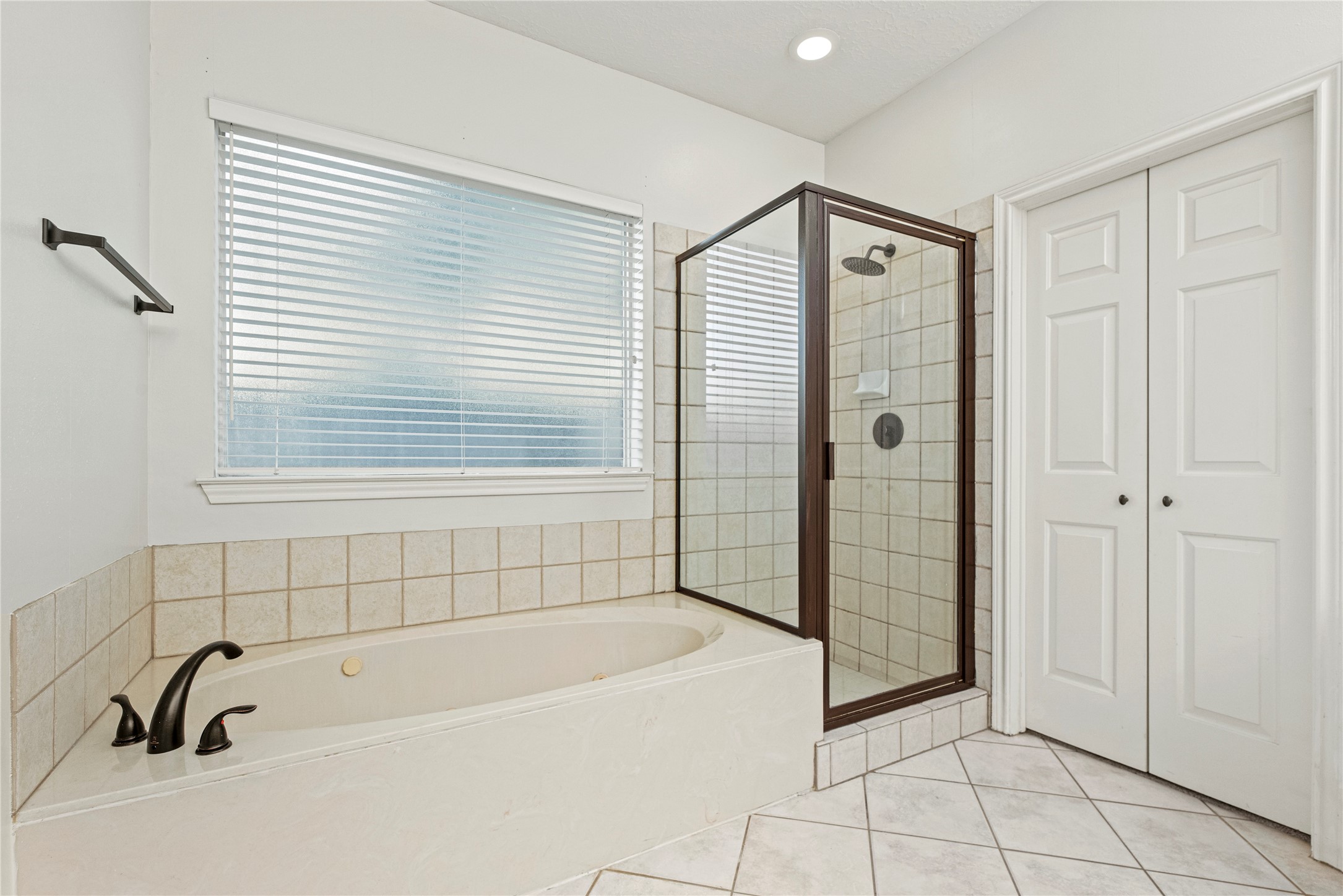 12502 Pavilion Court Tomball, TX 77377 - Photo 23 of 37 a bathroom with a bathtub and shower