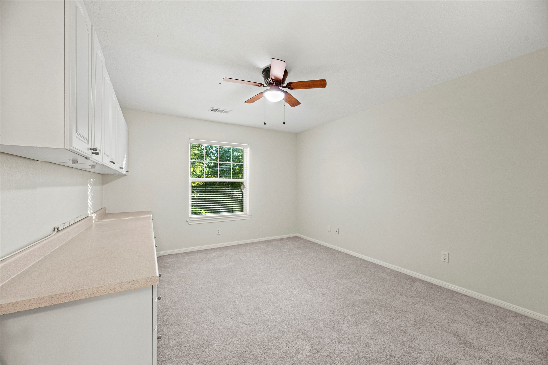 12502 Pavilion Court Tomball, TX 77377 - Photo 29 of 37 an empty room with windows and fan