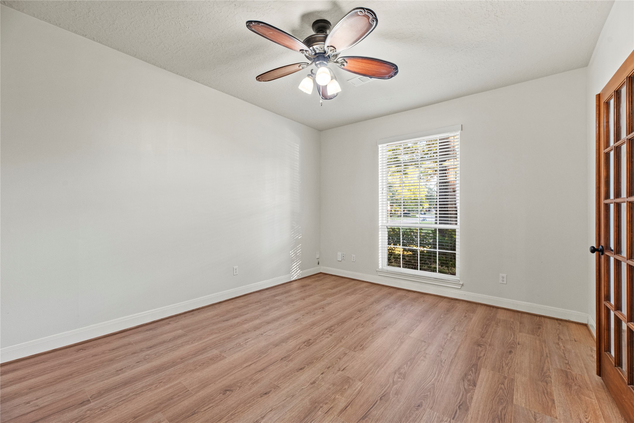 12502 Pavilion Court Tomball, TX 77377 - Photo 7 of 37 an empty room with wooden floor and windows
