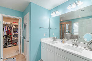 404 Hepburn Road Orange Park, FL 32065 - Photo 13 of 31 a bathroom with a double vanity sink and a mirror