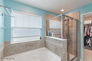 404 Hepburn Road Orange Park, FL 32065 - Photo 14 of 31 a bathroom with a bathtub and a shower