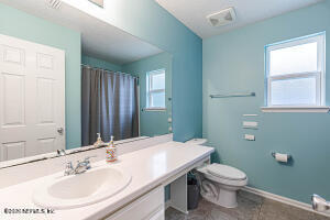 404 Hepburn Road Orange Park, FL 32065 - Photo 24 of 31 a bathroom with a sink a toilet and mirror