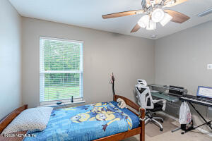 404 Hepburn Road Orange Park, FL 32065 - Photo 26 of 31 a bedroom with a bed and a chandelier