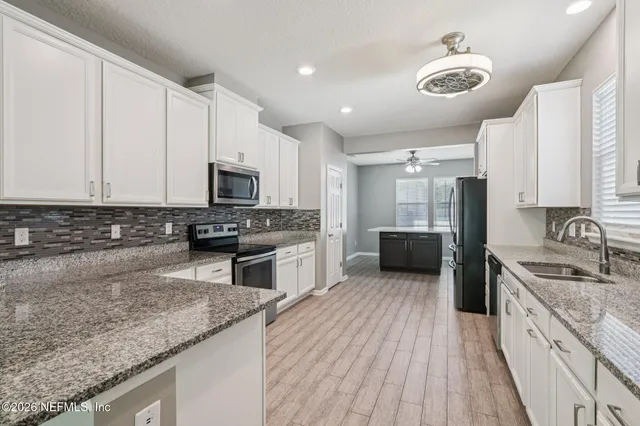 a bathroom with a toilet a sink and a mirror