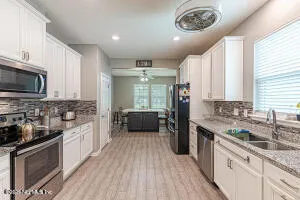 a kitchen with a sink stove and refrigerator