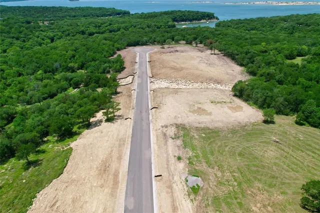 a picture of a yard in front of a brick wall