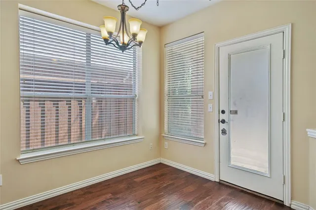 a view of a livingroom with wooden floor and a window