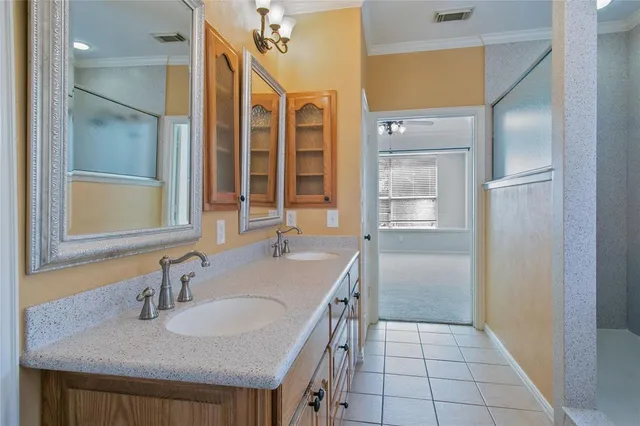 a bathroom with a granite countertop sink a mirror and a shower