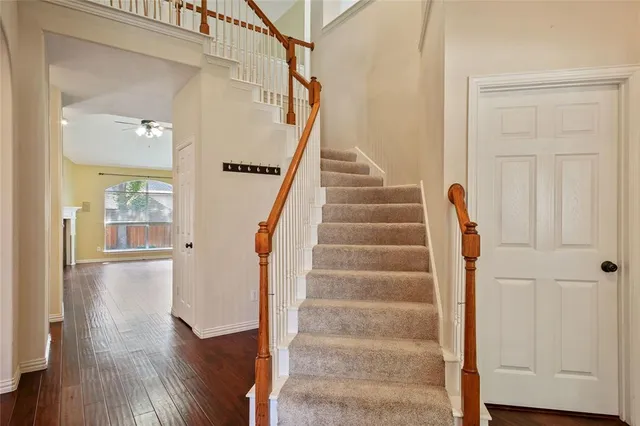 a view of staircase with white walls and railing