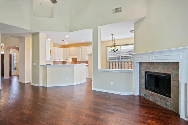 a view of a kitchen with wooden floor and a fireplace