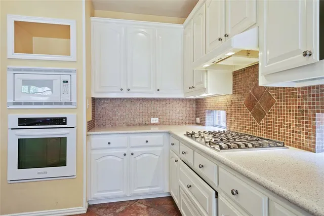 a kitchen with cabinets and appliances