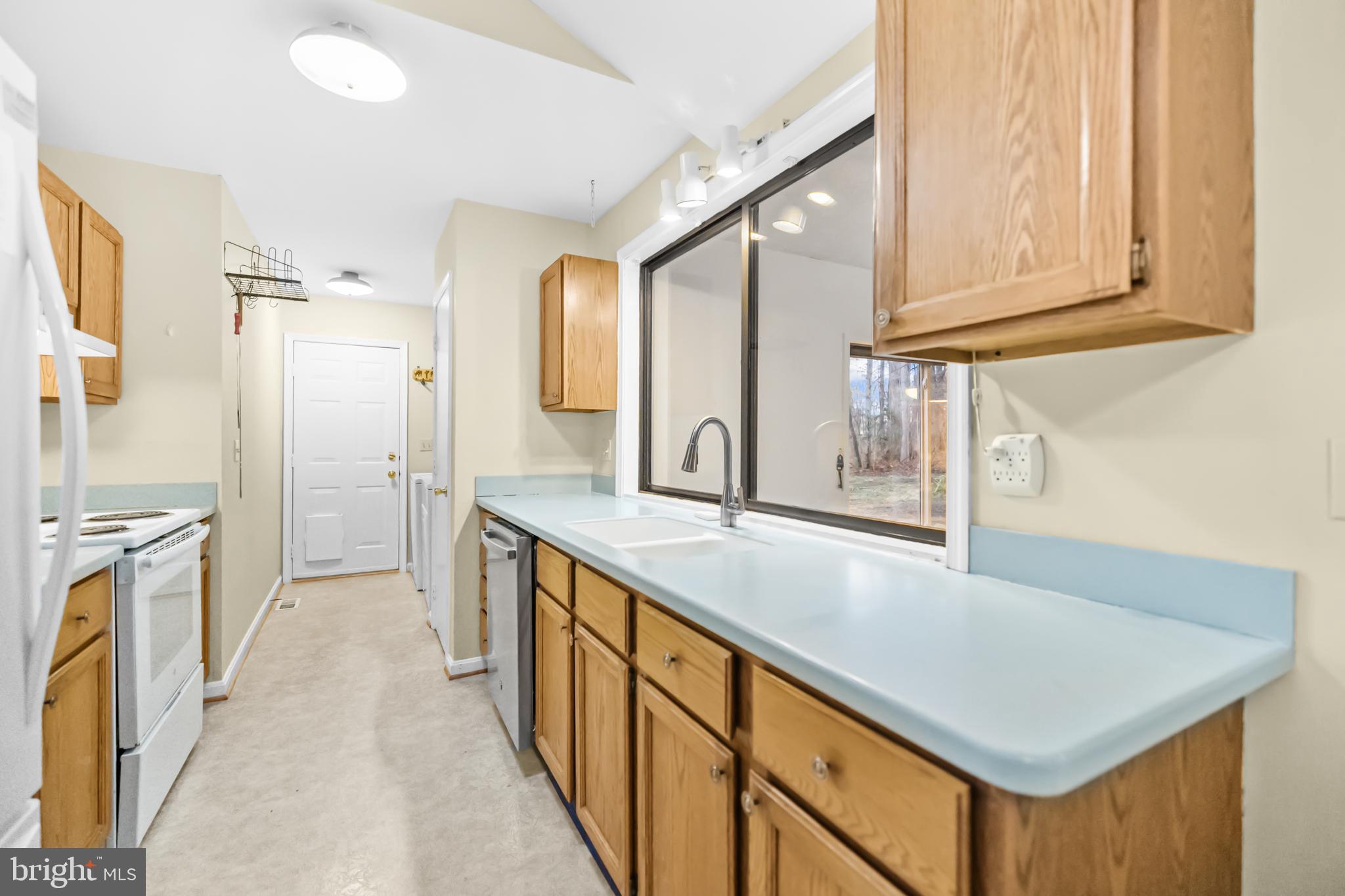 124 Saylers Creek Road Locust Grove, VA 22508 - Photo 12 of 55 a kitchen with stainless steel appliances granite countertop a sink and a refrigerator