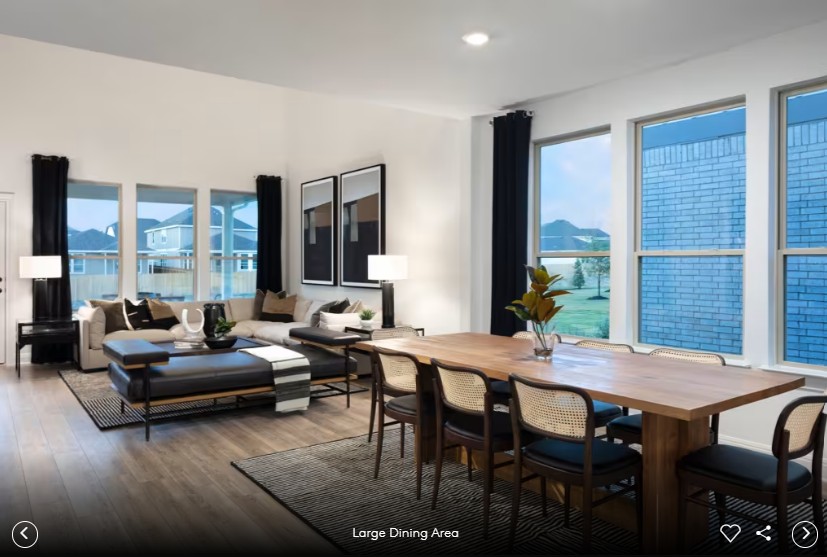 167 Poinsettia Road Buda, TX 78610 - Photo 5 of 9 a view of a dining room and livingroom with furniture wooden floor and a rug