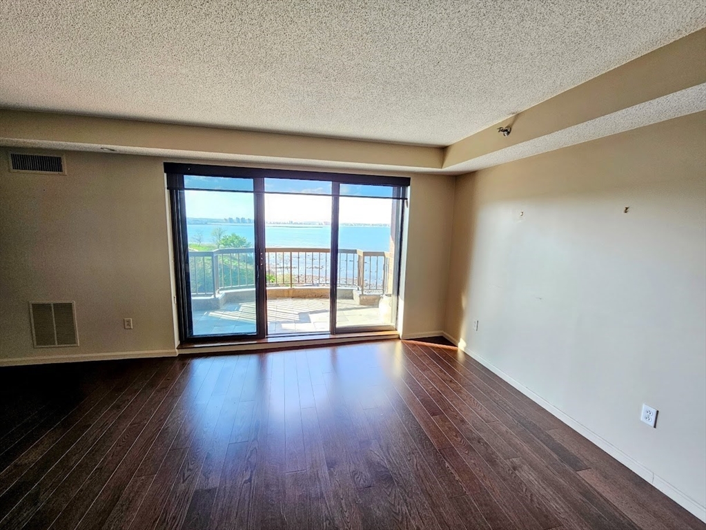 3 Seal Harbor Road, Unit 632 Winthrop, MA 02152 - Photo 3 of 34 a view of an empty room with wooden floor and a window