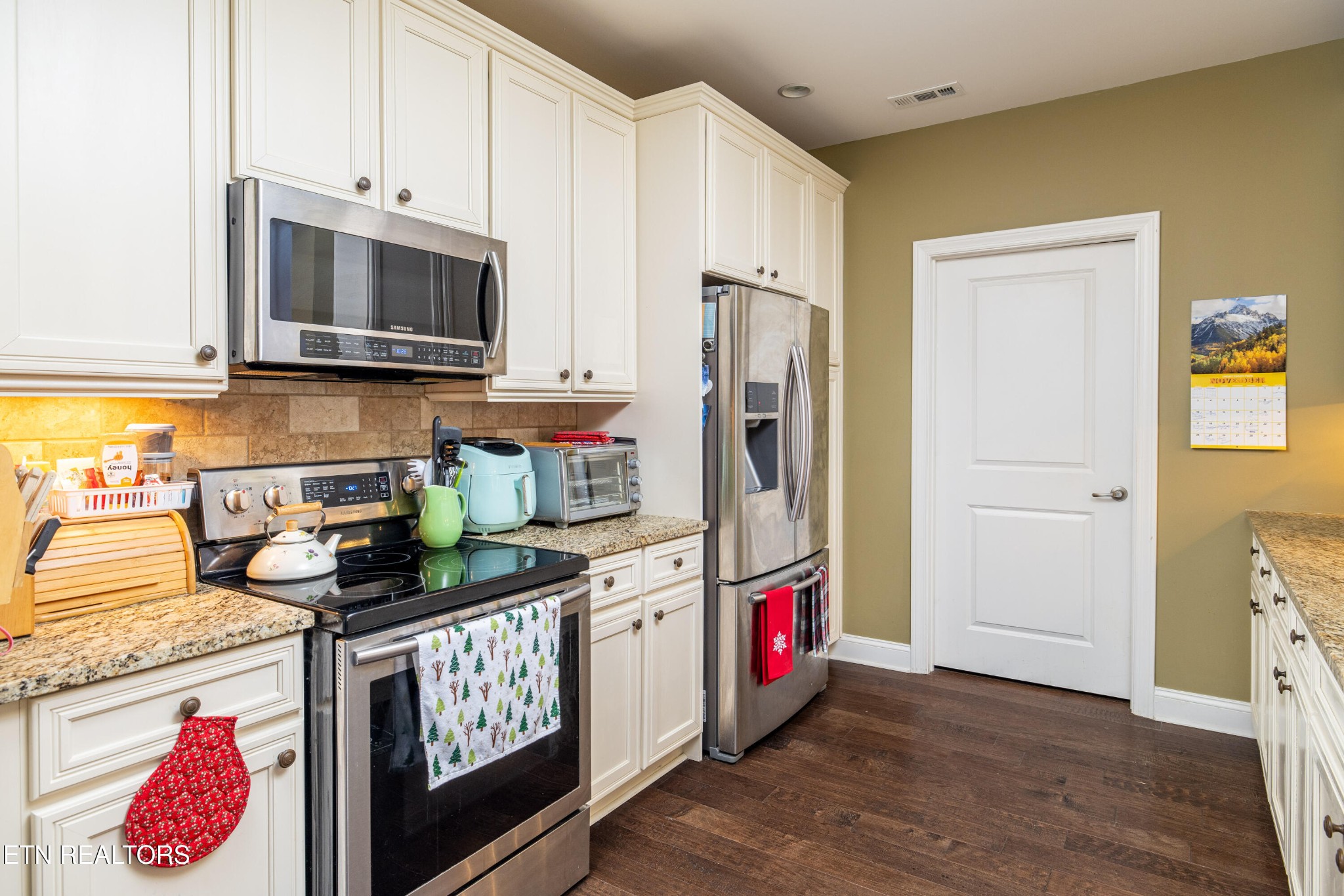 331 Centennial Bluff Boulevard Oak Ridge, TN 37830 - Photo 7 of 12 a kitchen with stainless steel appliances granite countertop a refrigerator and a stove top oven