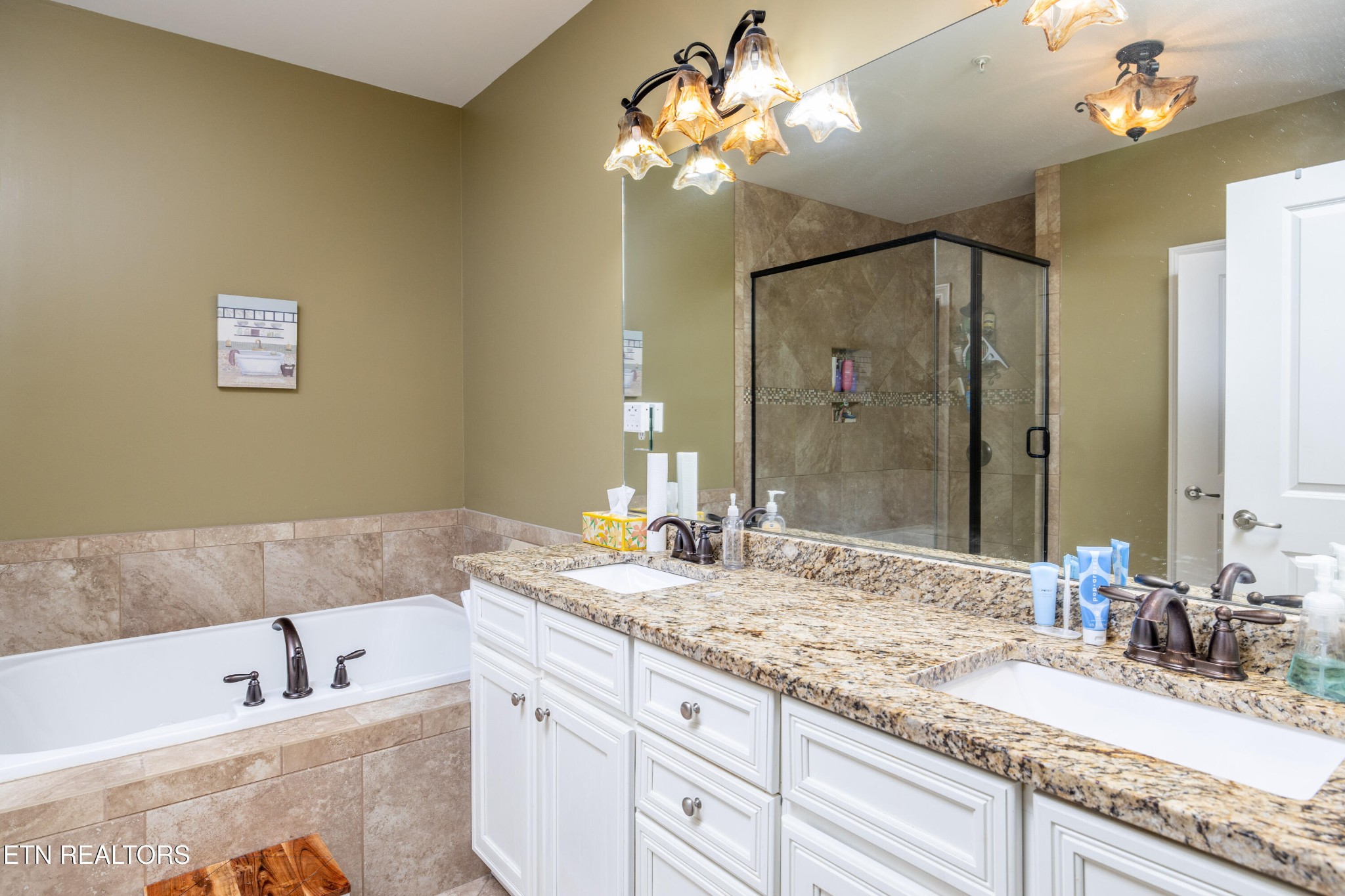 331 Centennial Bluff Boulevard Oak Ridge, TN 37830 - Photo 10 of 12 a bathroom with a granite countertop sink a large mirror and a bathtub
