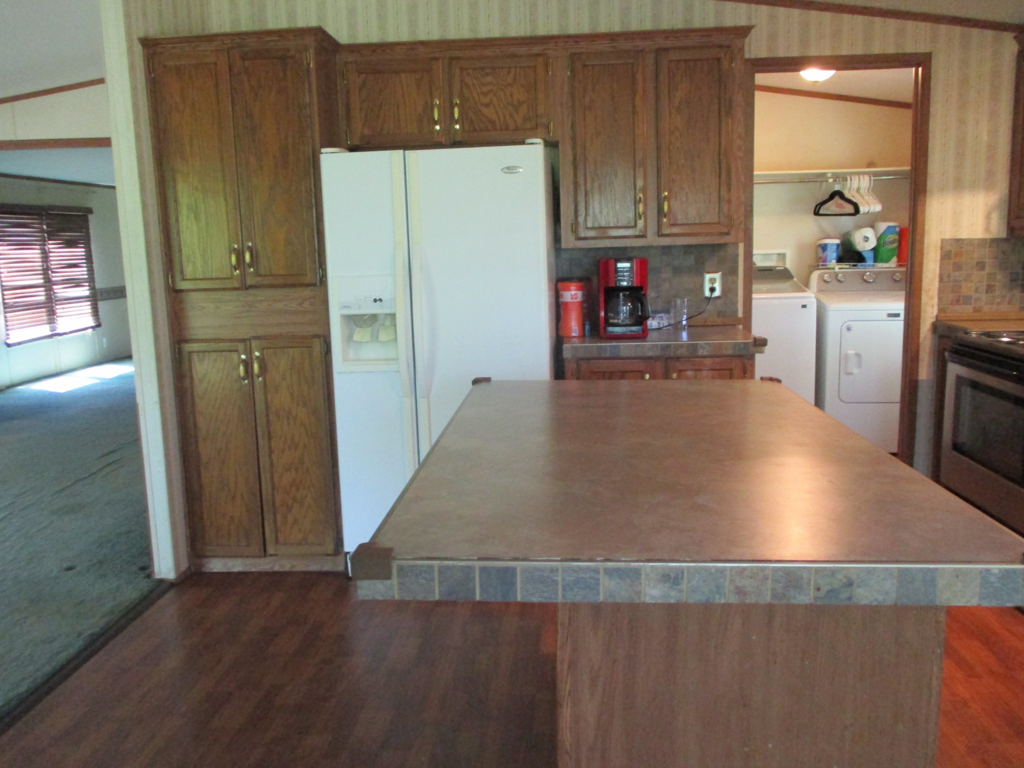 2080 North Commerce Road Lebanon, TN 37090 - Photo 6 of 40 a kitchen with granite countertop a refrigerator and a stove top oven