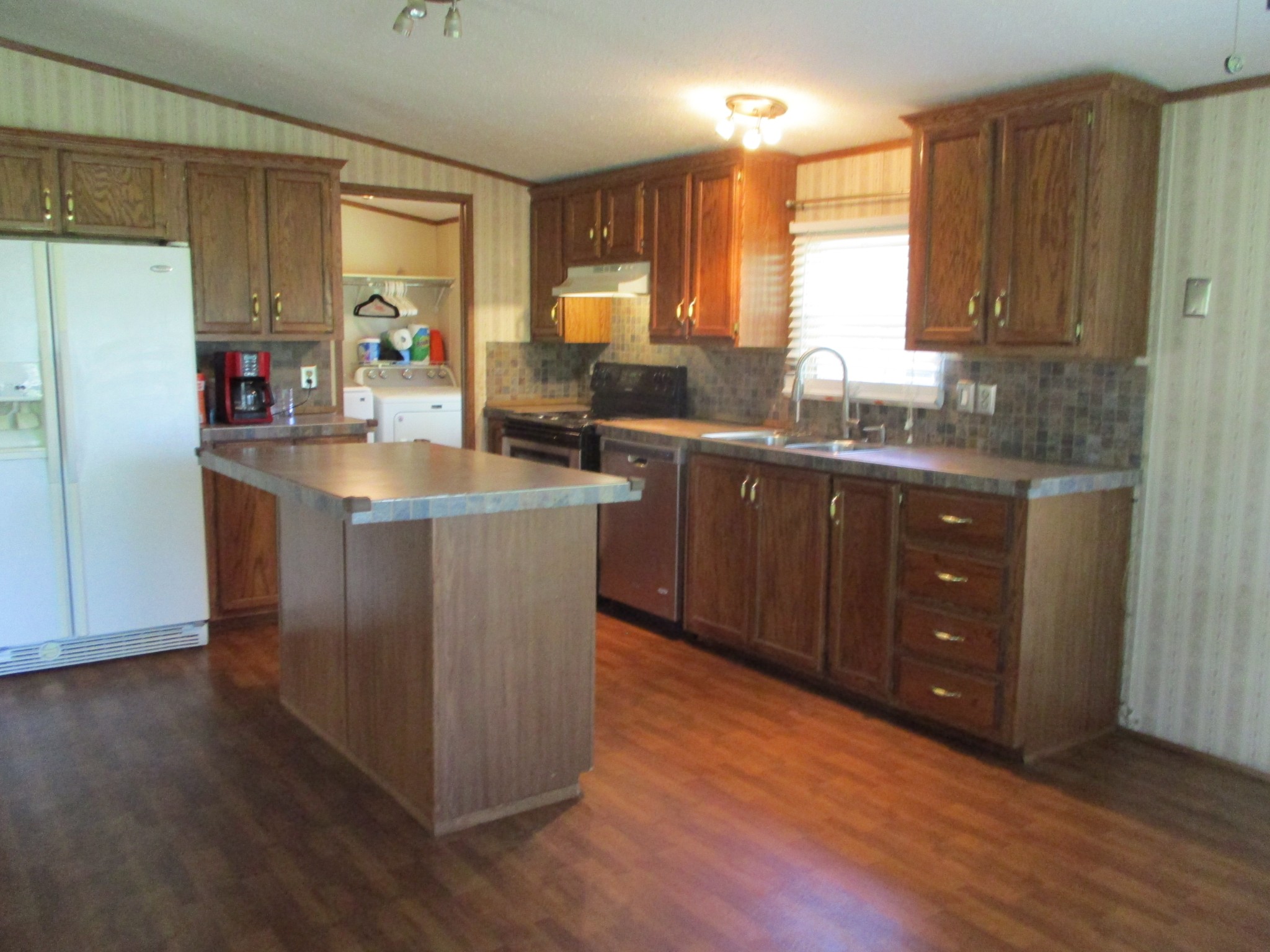 2080 North Commerce Road Lebanon, TN 37090 - Photo 7 of 40 a kitchen with stainless steel appliances granite countertop a sink a stove and refrigerator