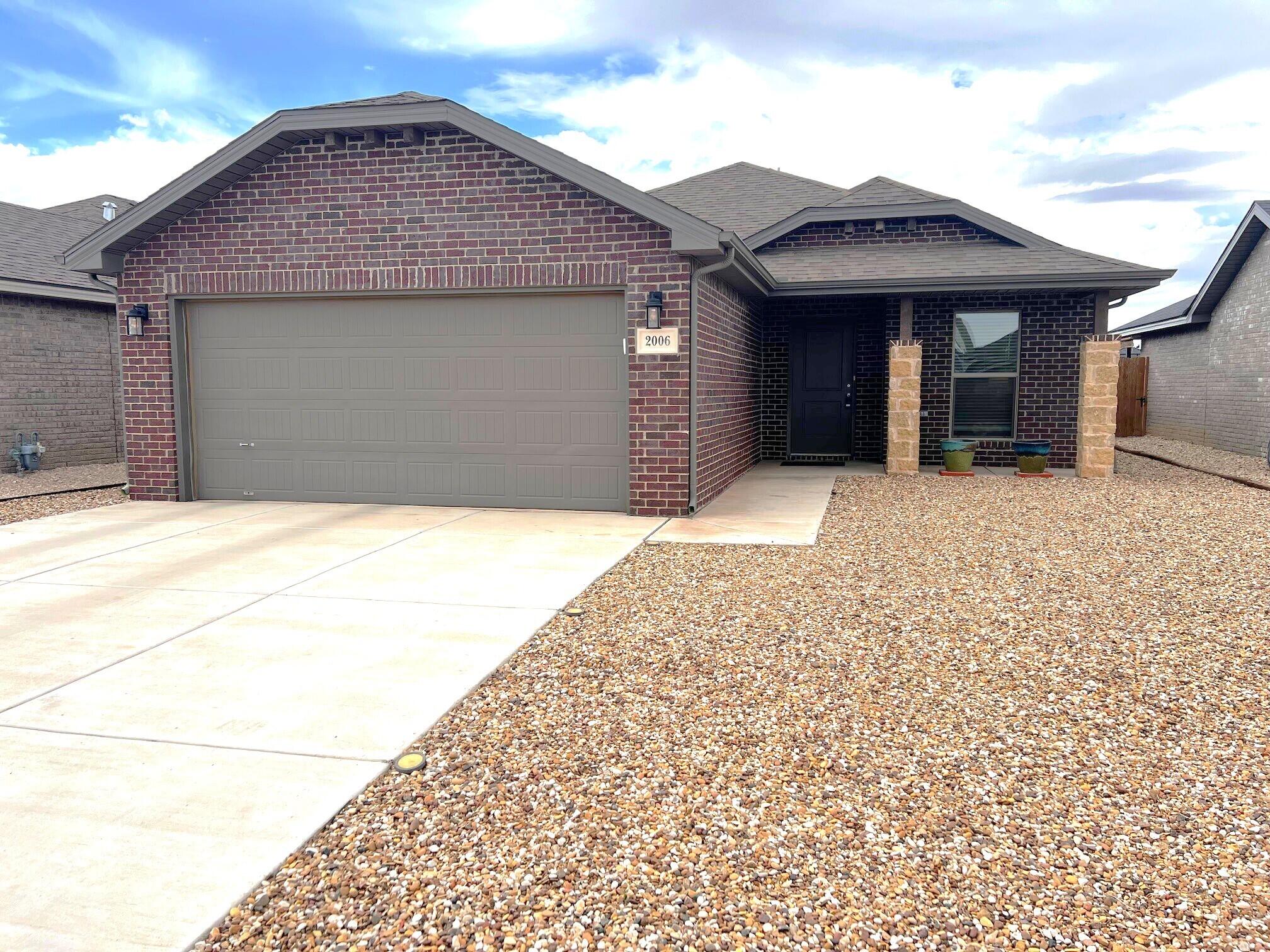 2006 135th Street Lubbock, TX 79423 - Photo 1 of 24 a front view of a house with a yard