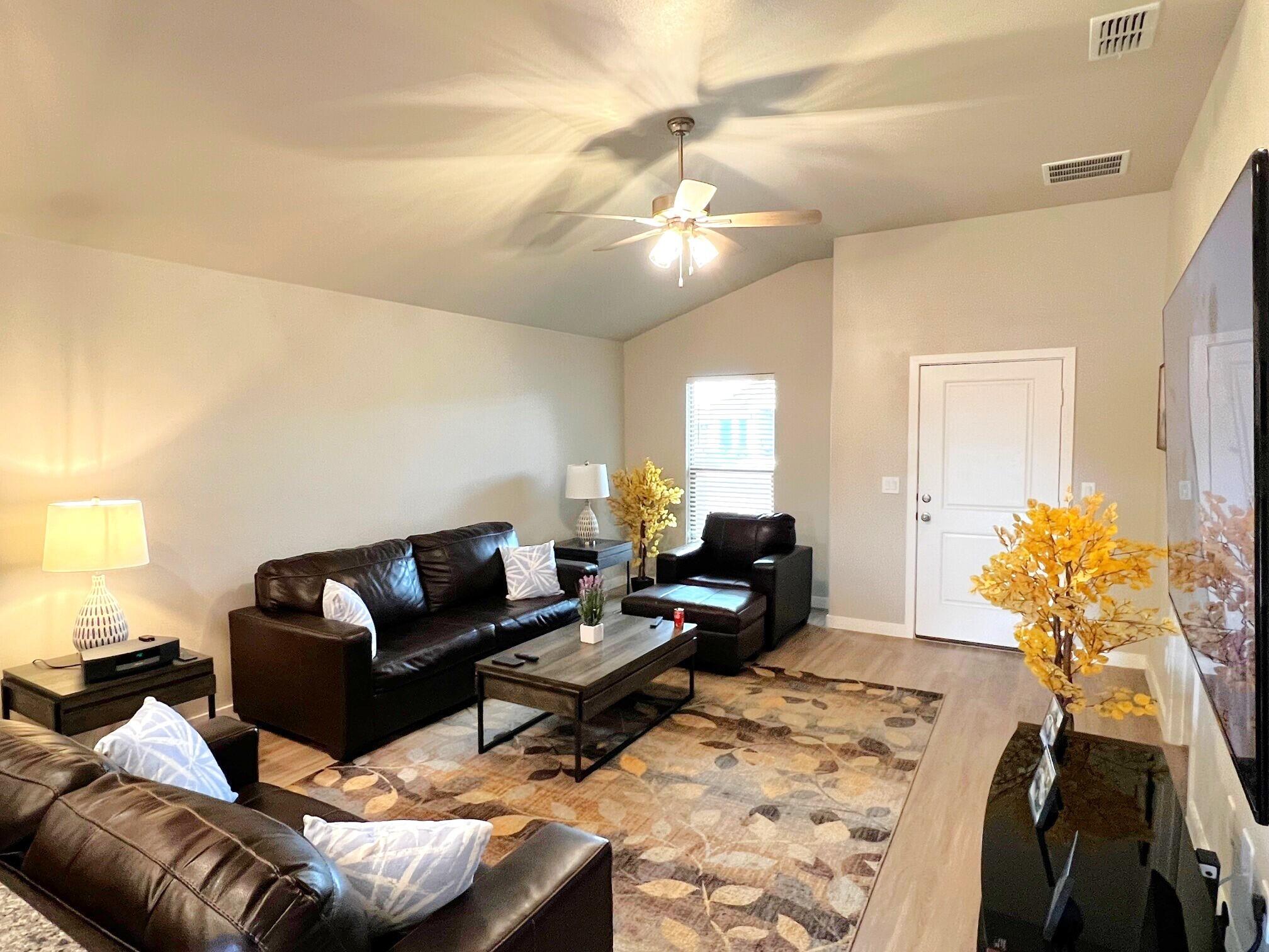 2006 135th Street Lubbock, TX 79423 - Photo 11 of 24 a living room with furniture and a chandelier