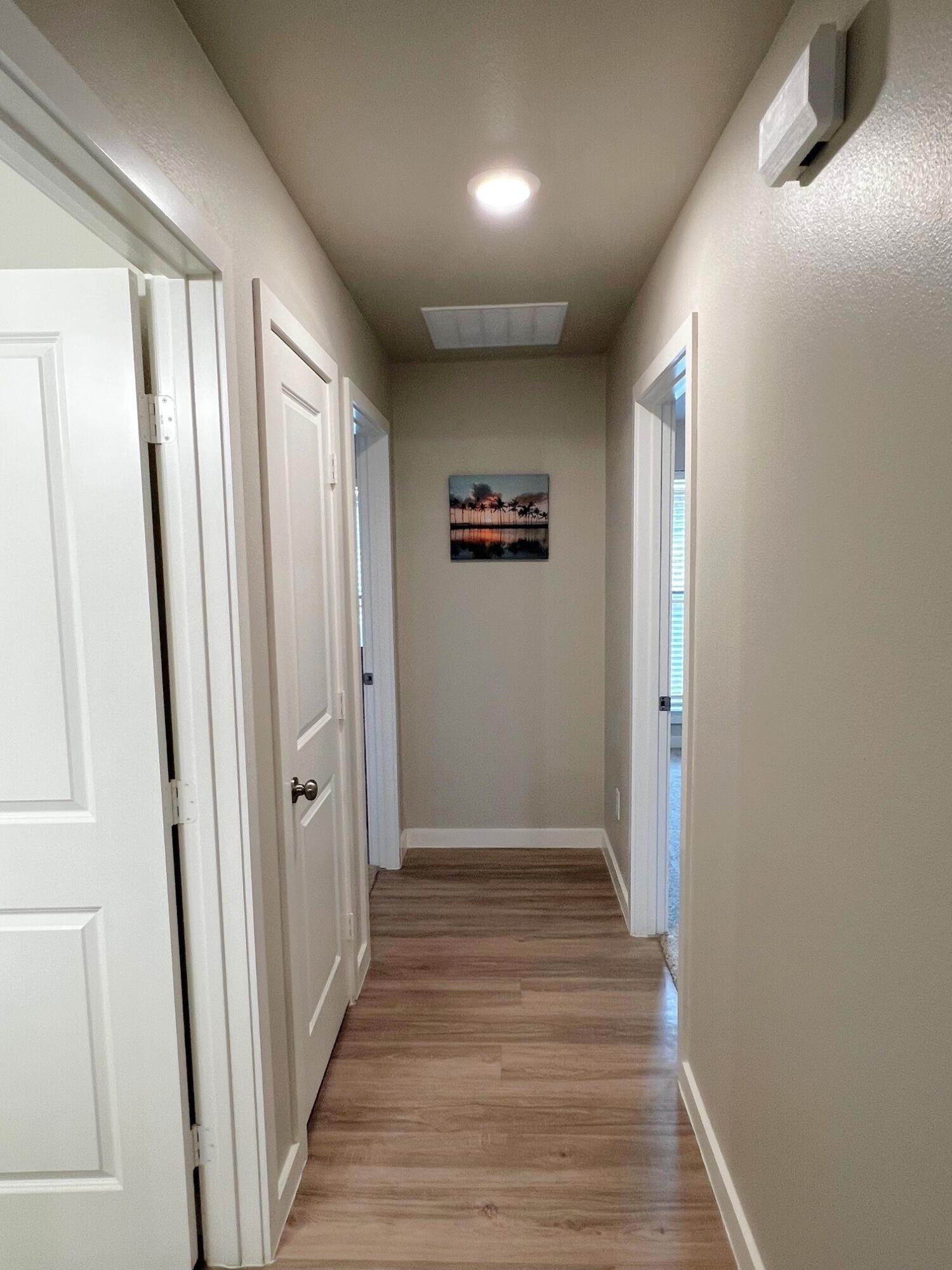 2006 135th Street Lubbock, TX 79423 - Photo 14 of 24 a view of a hallway with wooden floor and staircase
