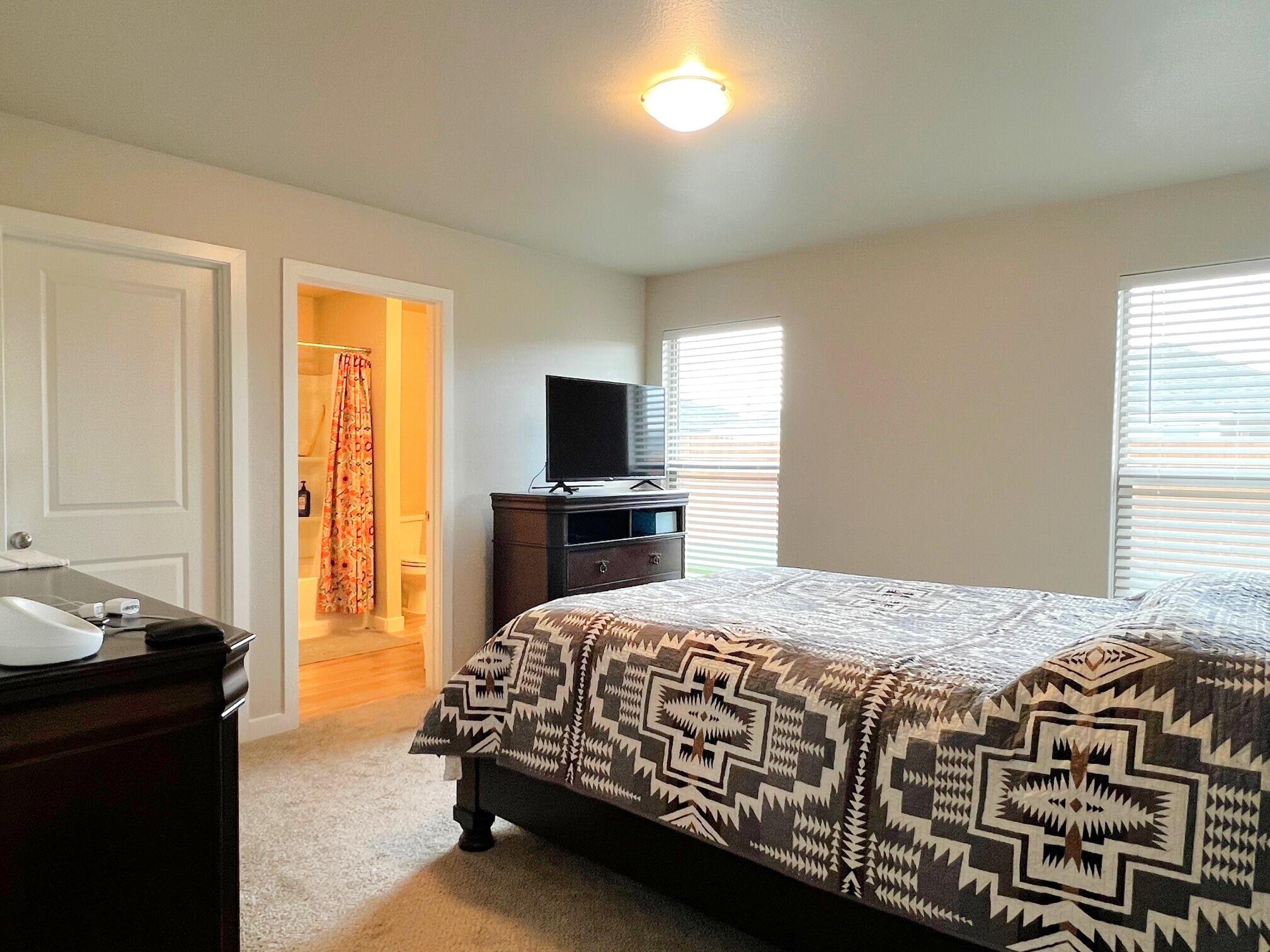 2006 135th Street Lubbock, TX 79423 - Photo 17 of 24 a bedroom with a bed and a window