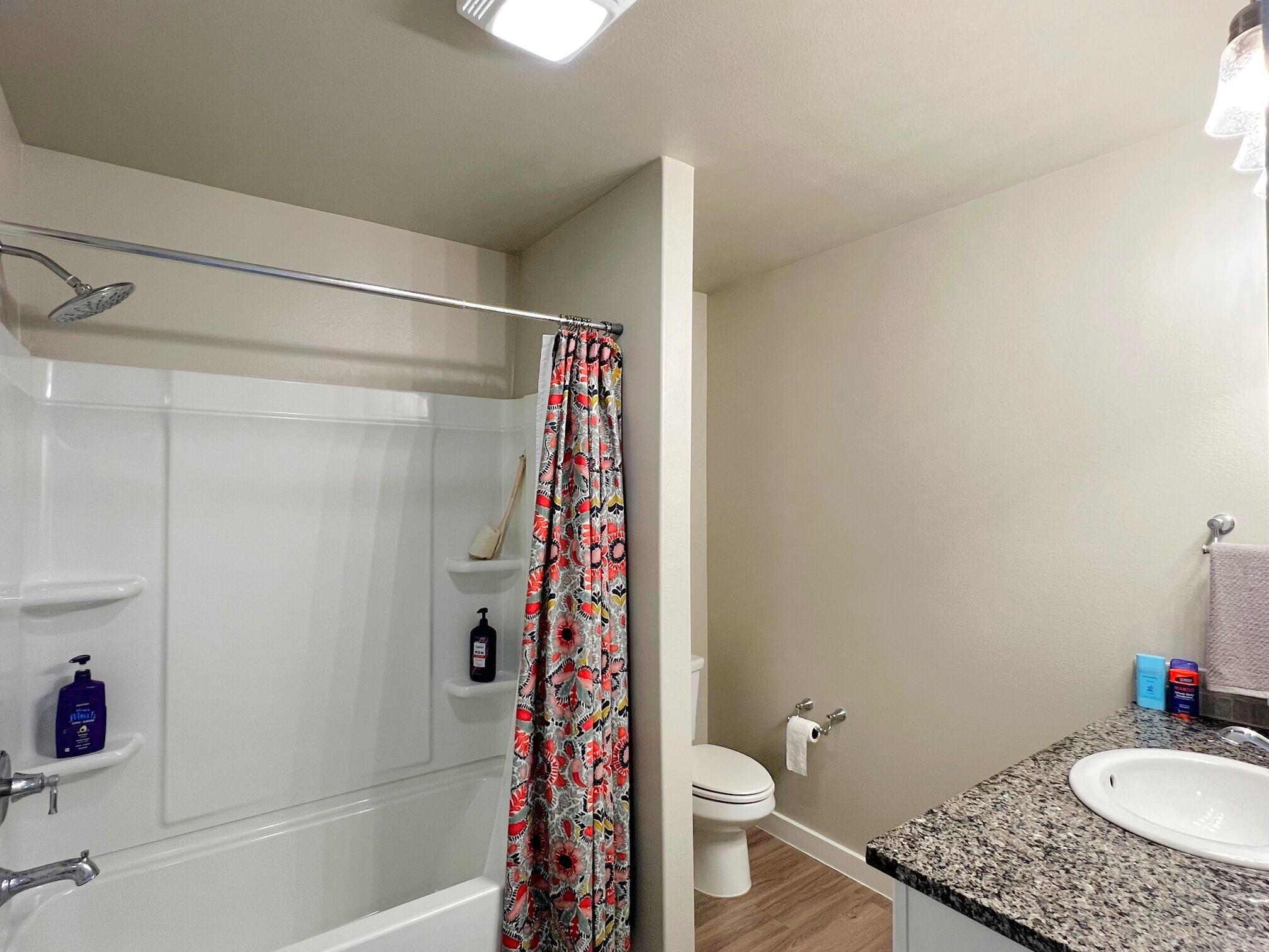 2006 135th Street Lubbock, TX 79423 - Photo 19 of 24 a bathroom with a sink toilet and shower