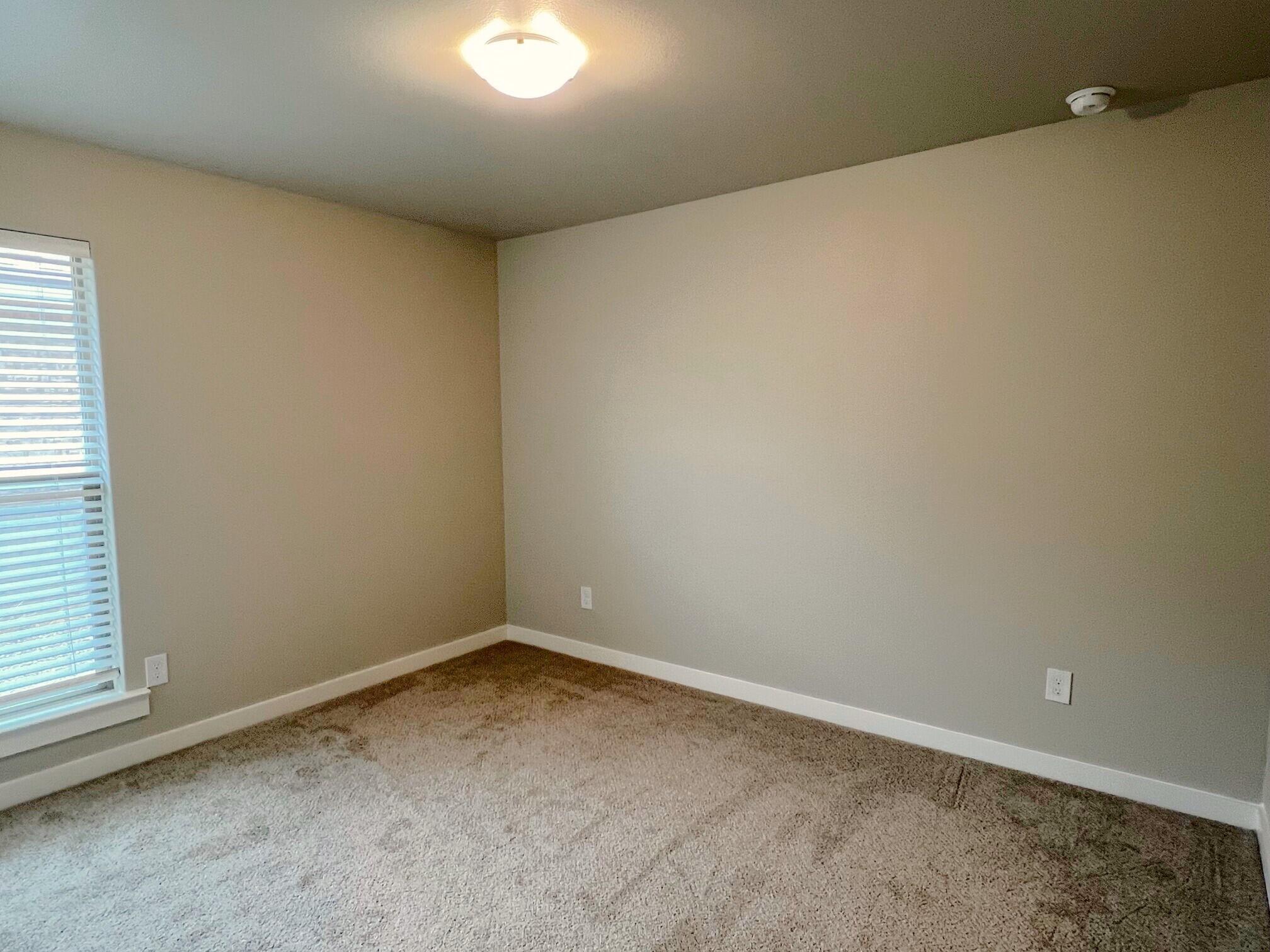 2006 135th Street Lubbock, TX 79423 - Photo 20 of 24 an empty room with a empty space and window