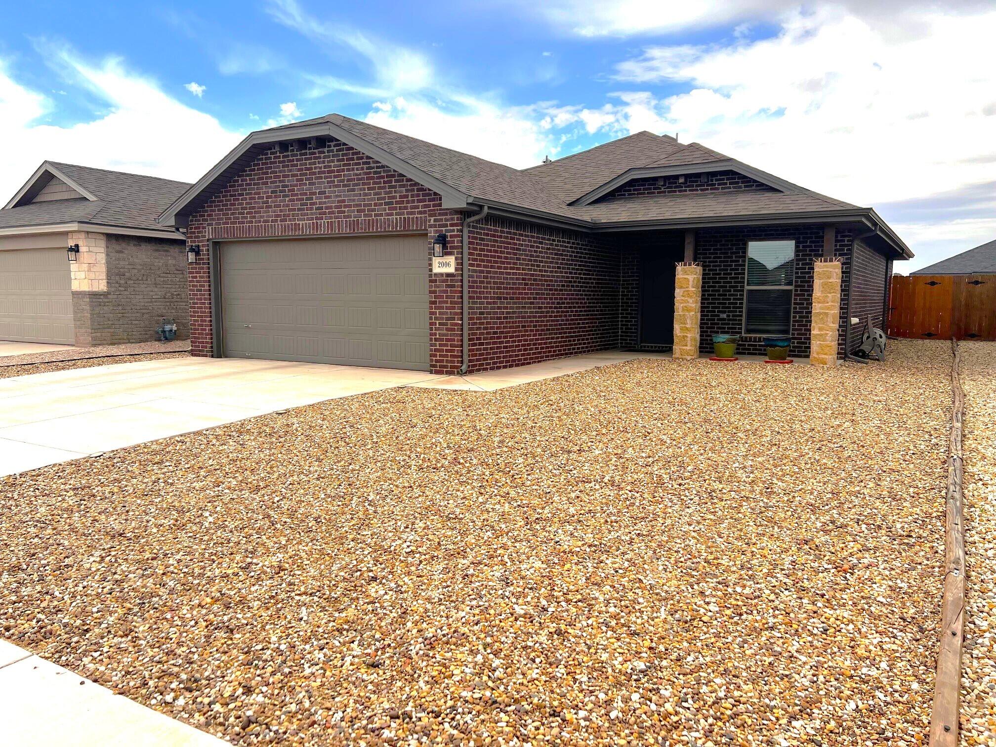 2006 135th Street Lubbock, TX 79423 - Photo 2 of 24 front view of a house with a yard