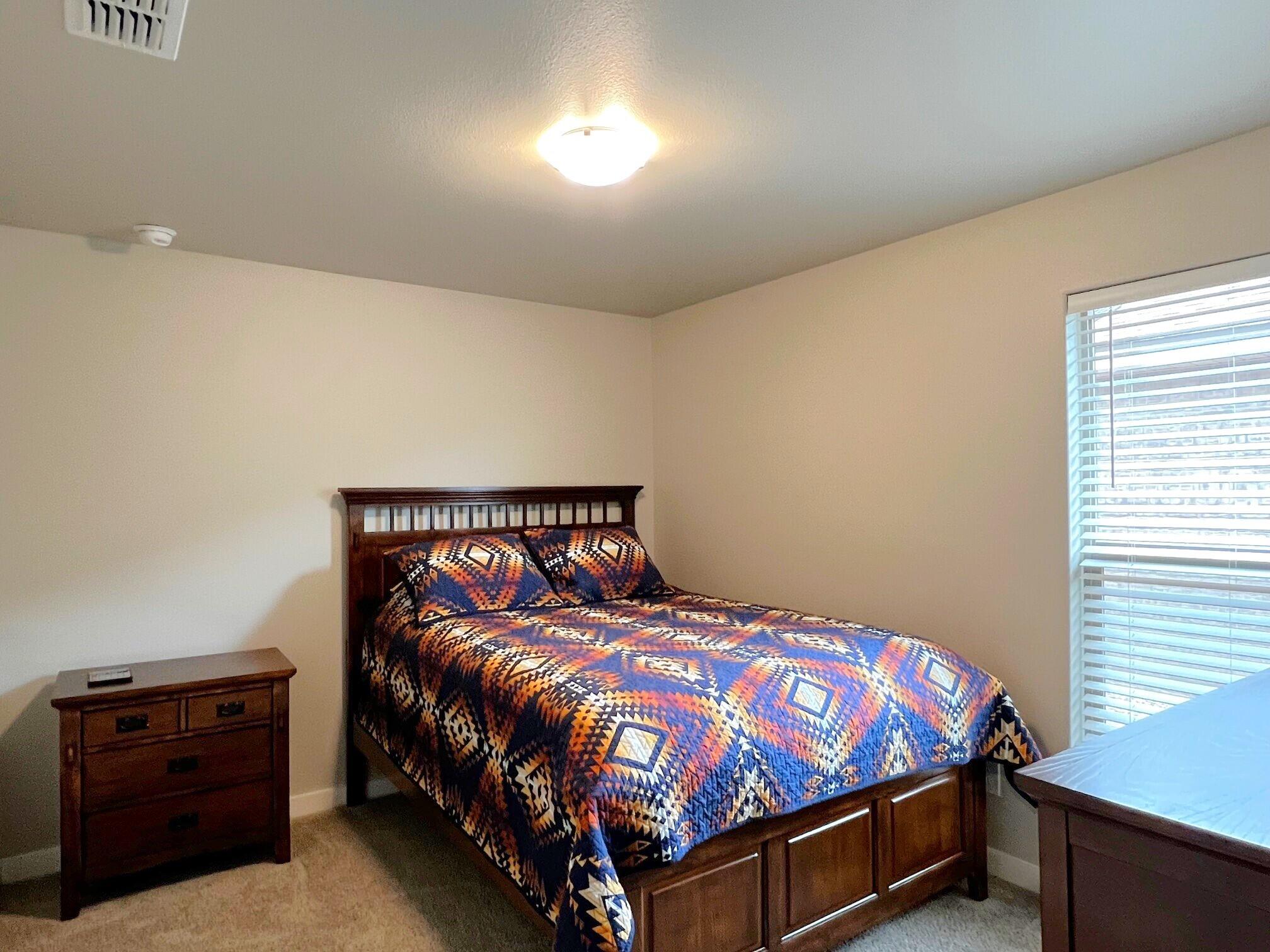 2006 135th Street Lubbock, TX 79423 - Photo 24 of 24 a bedroom with a bed and a dresser